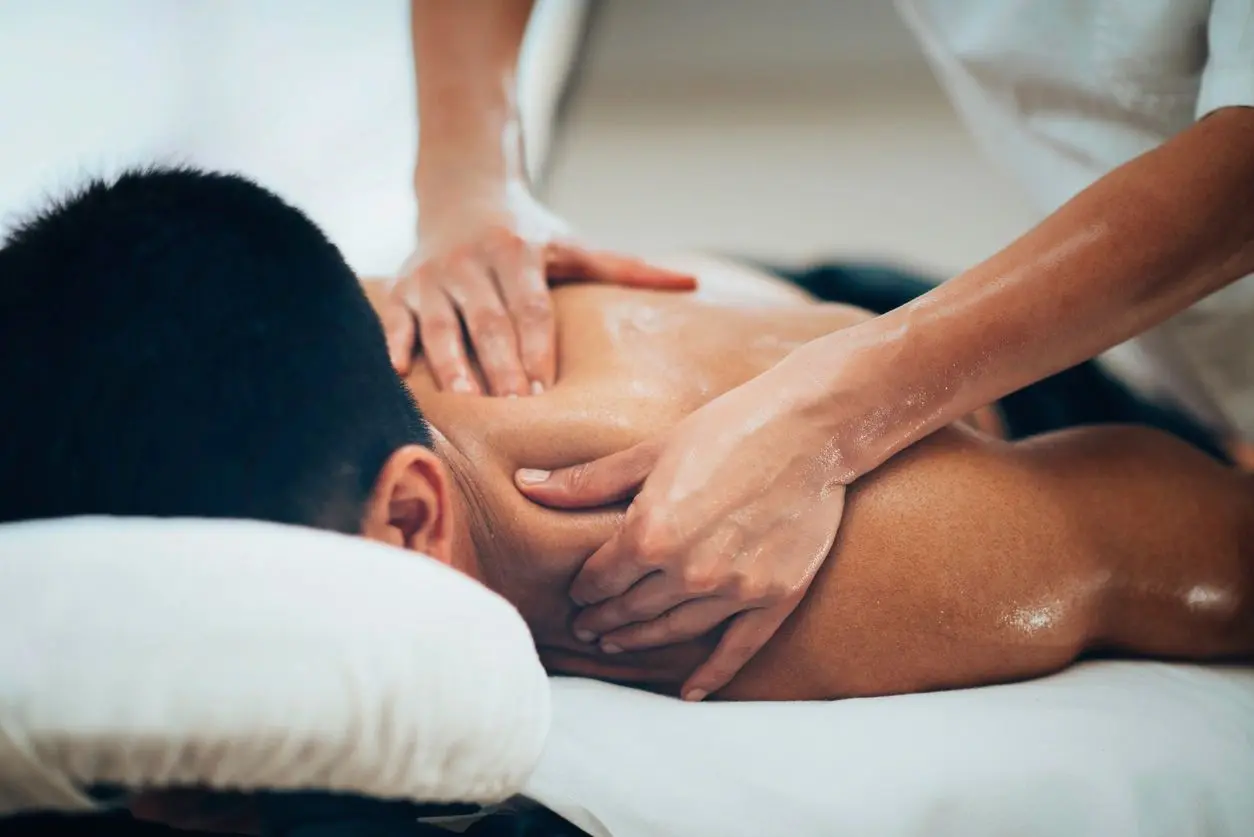 A man getting his back examined by an osteopath.