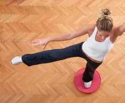 A woman is doing an exercise on the floor